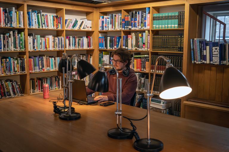 Man using laptop in library