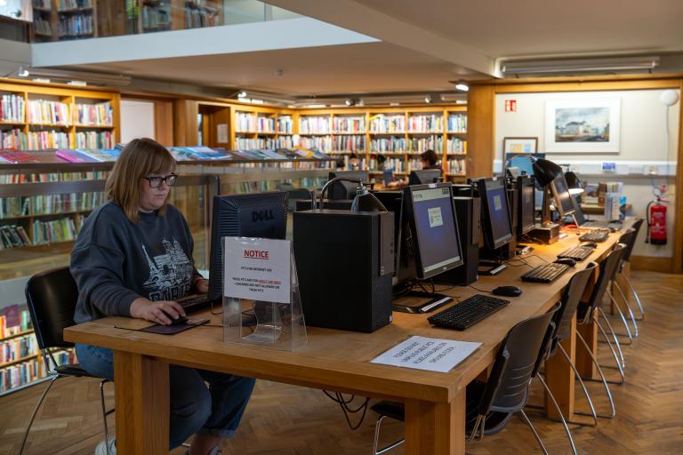 Woman on computer in library