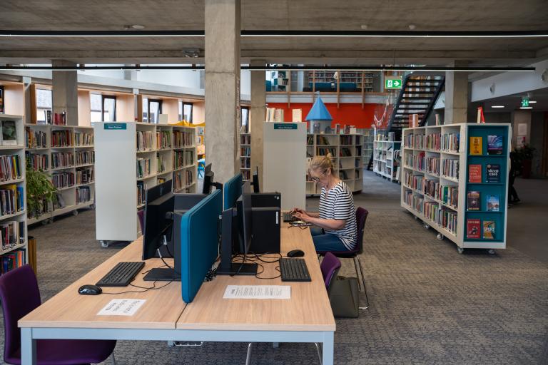 Woman on computer in library