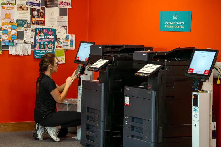 Girl printing documents in library