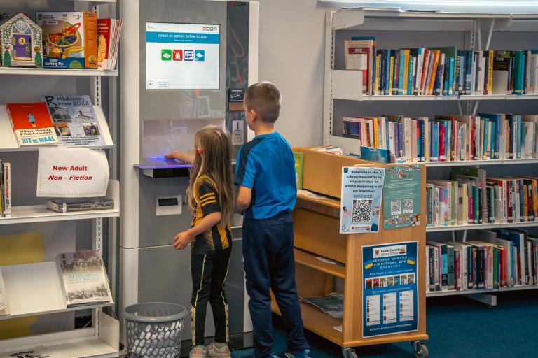 Children checking out library books