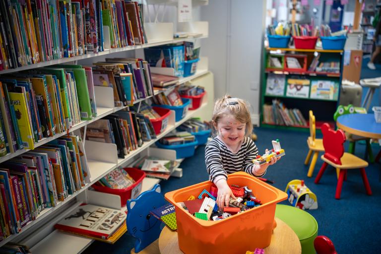 Girl playing with toy bricks