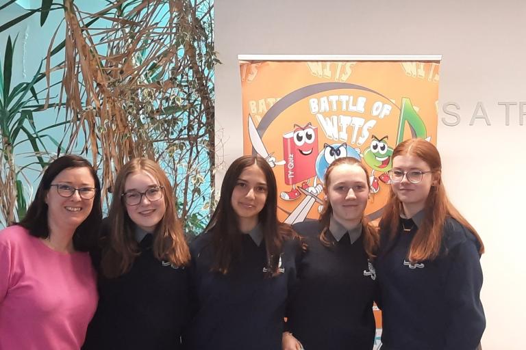 Teenage girls in library with librarian