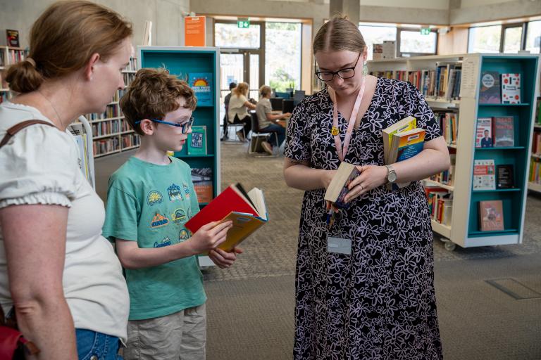 Library staff assisting customers