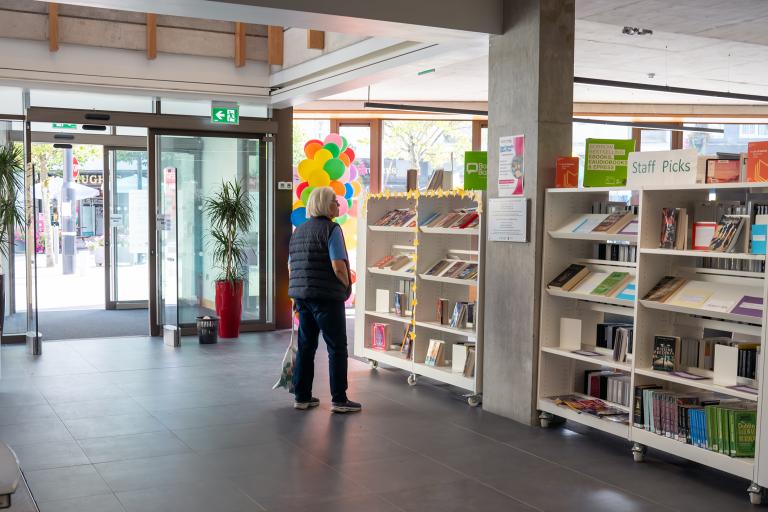 Woman browsing shelves in library