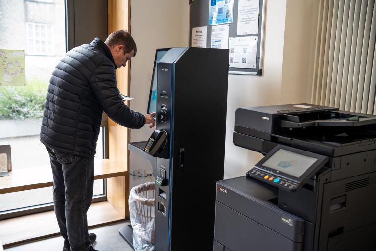 Man remotely printing in the library