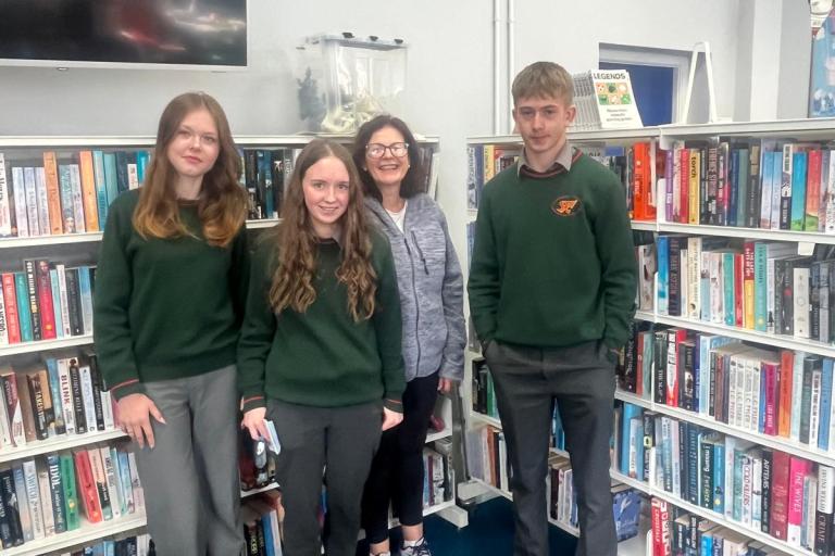 Students in front of library shelves