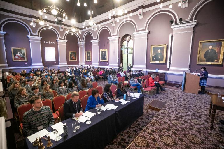 Audience listening to debate speakers