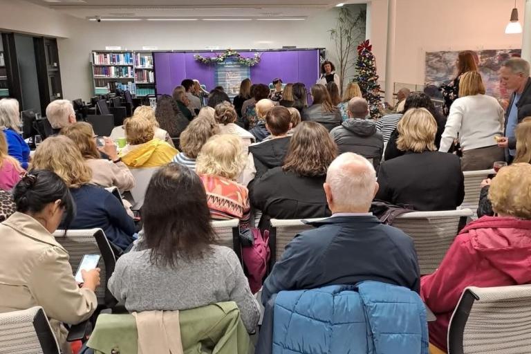 Crowd watching author at library