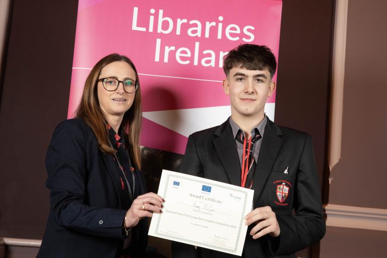 Woman presenting certificate to student