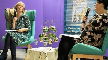 2 women in conversation about book in library