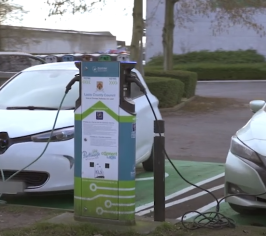 Electric cars plugged into EV charging point